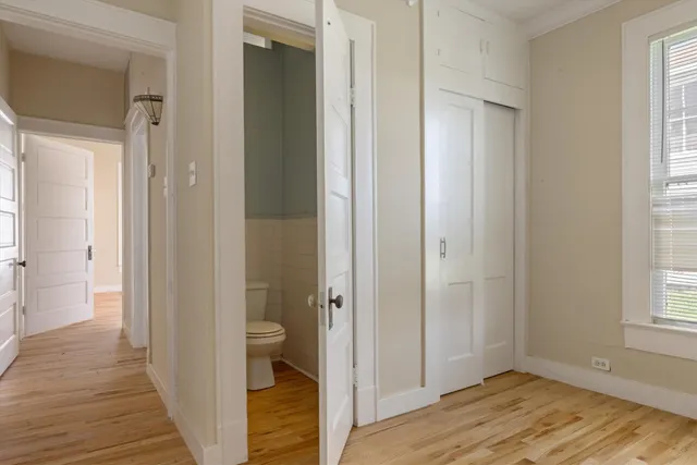 a view of a bathroom from the hallway and a room