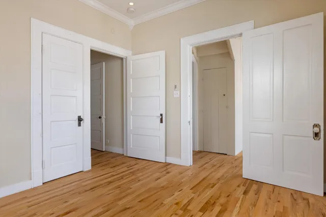 a view of hallway with wooden floor