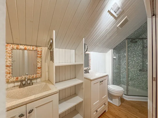 a kitchen with a sink cabinets stainless steel appliances and a window