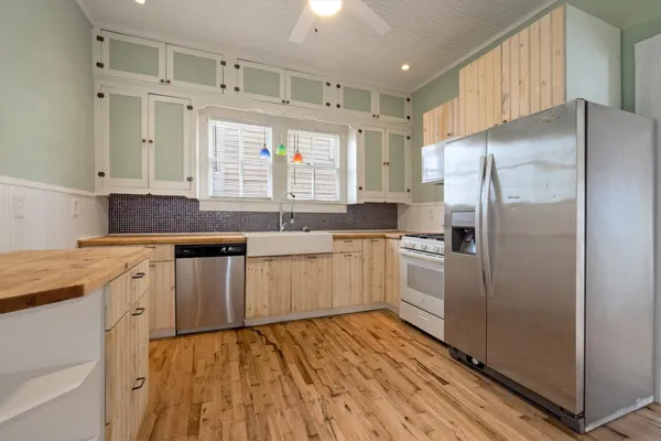 a kitchen with stainless steel appliances a refrigerator sink and cabinets