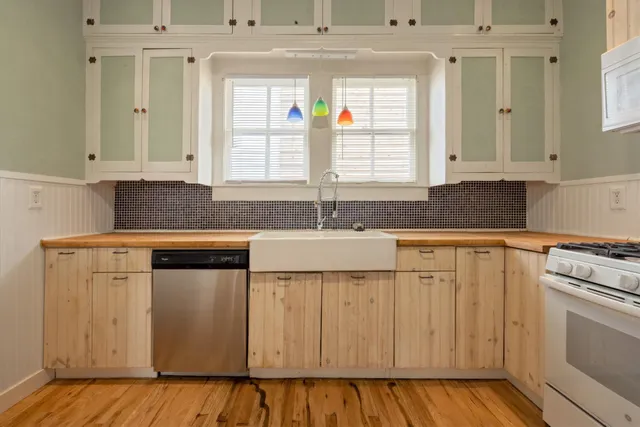 a kitchen with granite countertop a sink and cabinets