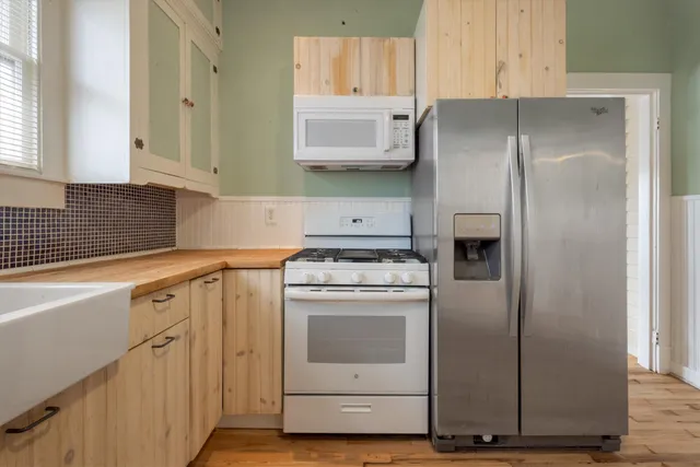 a kitchen with cabinets and stainless steel appliances