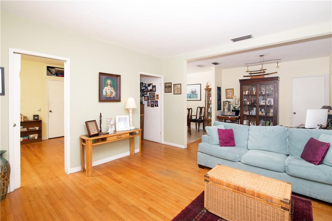 a living room with furniture and kitchen view