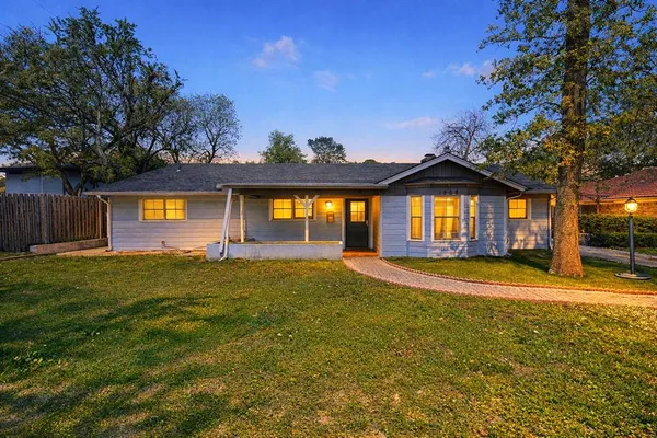 a view of a house with a backyard