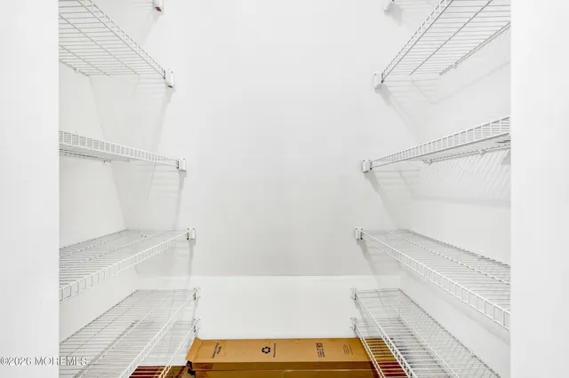a kitchen with a sink and wooden floor