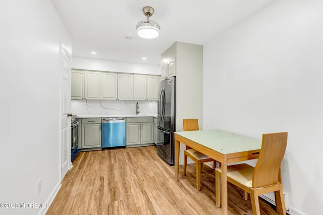 a kitchen with stainless steel appliances granite countertop a refrigerator and a sink