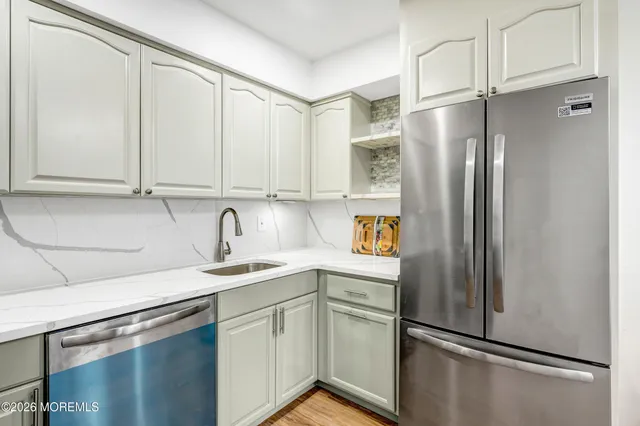a view of a kitchen with furniture and wooden floor