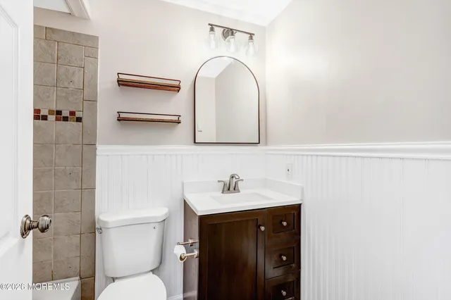 a view of a big room with wooden floor and a ceiling fan
