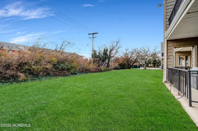 front view of a brick building with a yard