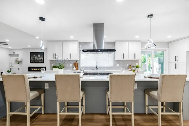 a kitchen with kitchen island white cabinets and white appliances