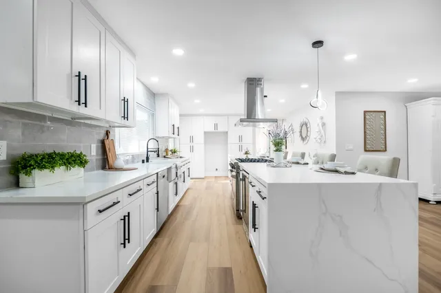 a kitchen with kitchen island granite countertop lots of counter top space and sink