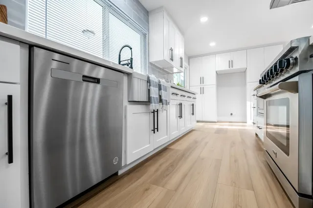 a view of a kitchen with wooden floor and electronic appliances