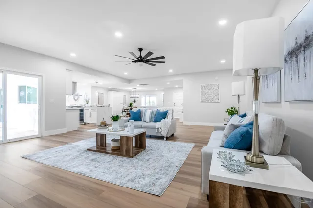 a living room with furniture and wooden floor