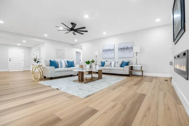 a living room with furniture and kitchen view