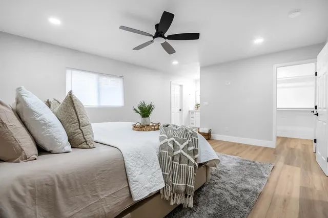 a bedroom with a bed and a chandelier