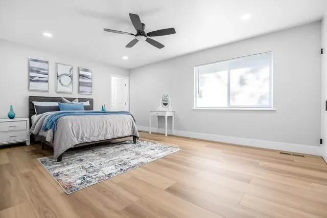 a bedroom with a large bed and a window