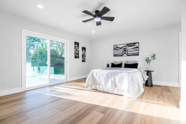 a bedroom with a large bed and a large window