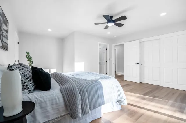 a bed room with a bed and a potted plant