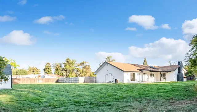 a view of a house with a yard and a garden