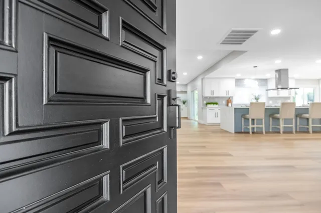 a kitchen with stainless steel appliances kitchen island granite countertop a stove top oven and cabinets