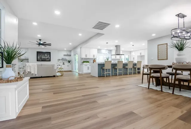 a large kitchen with a table and chairs in it