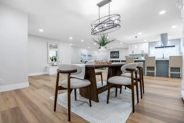 a view of a dining room with furniture wooden floor and chandelier
