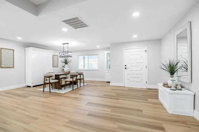 a view of dining room with furniture and wooden floor