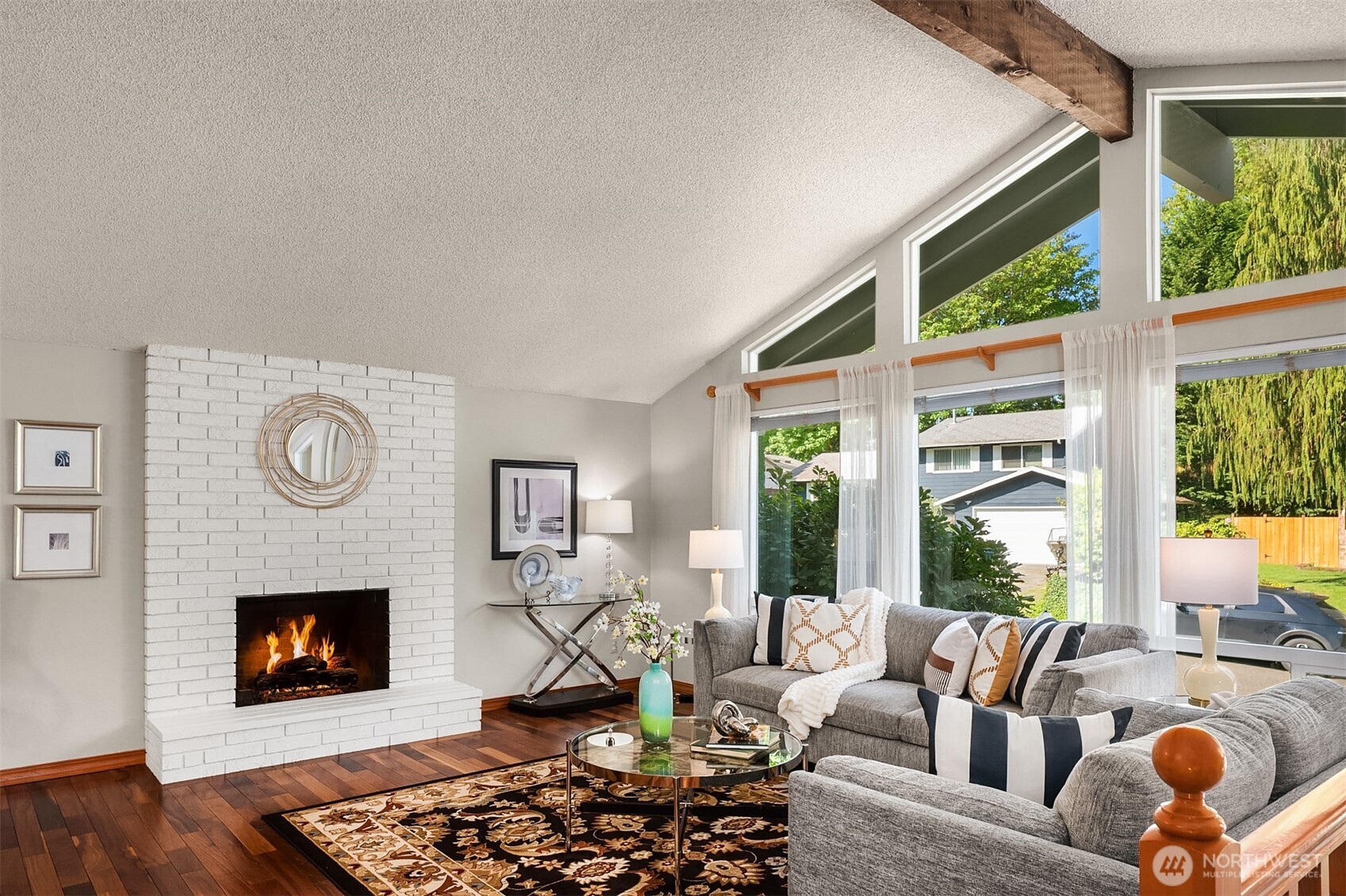 21331 2nd Avenue Southeast Bothell, WA 98021 - Photo 9 of 34 a living room with furniture a fireplace and a large window