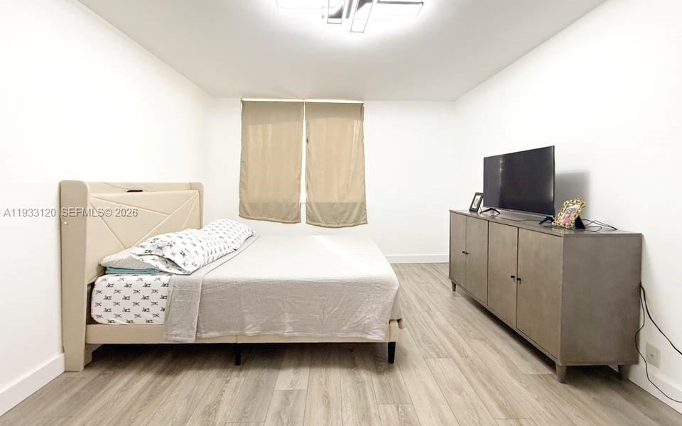 9125 Southwest 77th Avenue, Unit 307 Miami, FL 33156 - Photo 15 of 21 a bedroom with a bed and flat screen tv