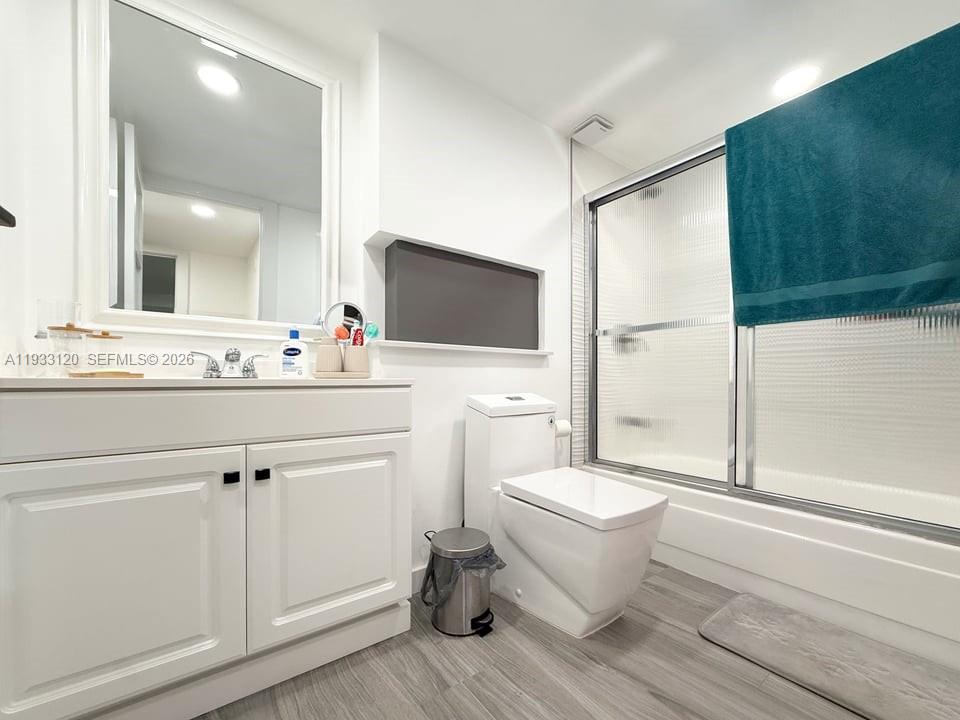 9125 Southwest 77th Avenue, Unit 307 Miami, FL 33156 - Photo 16 of 21 a bathroom with a toilet sink and mirror