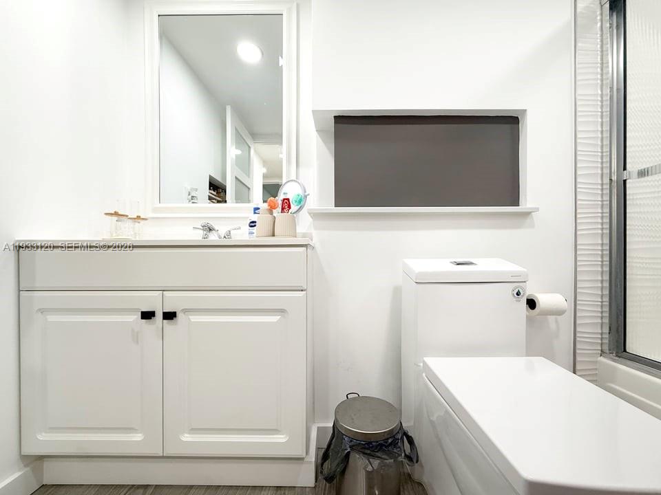 9125 Southwest 77th Avenue, Unit 307 Miami, FL 33156 - Photo 17 of 21 a bathroom with a sink toilet a mirror and bathtub