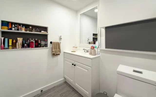 a kitchen with granite countertop a sink a stove and cabinets
