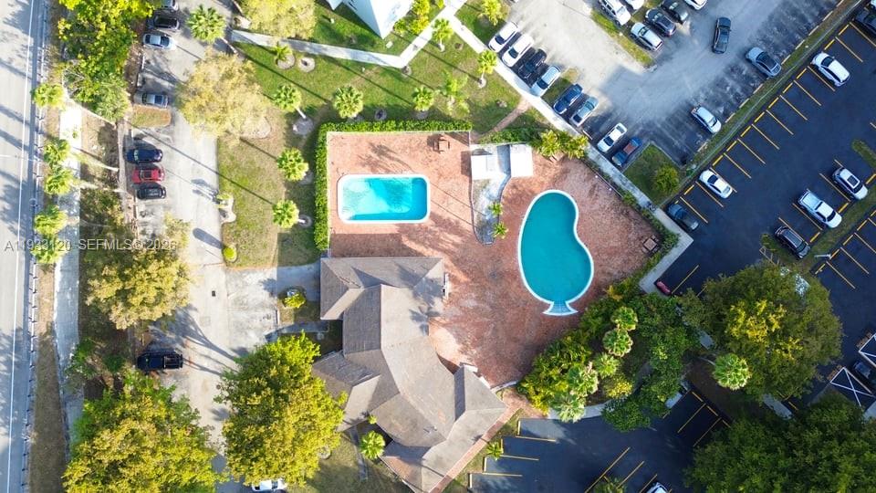 9125 Southwest 77th Avenue, Unit 307 Miami, FL 33156 - Photo 5 of 21 a aerial view of a house with a swimming pool and large trees