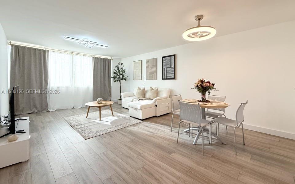 9125 Southwest 77th Avenue, Unit 307 Miami, FL 33156 - Photo 7 of 21 a living room with furniture and a wooden floor