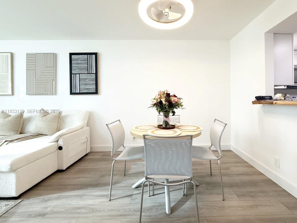 9125 Southwest 77th Avenue, Unit 307 Miami, FL 33156 - Photo 8 of 21 a view of a dining room with furniture and wooden floor