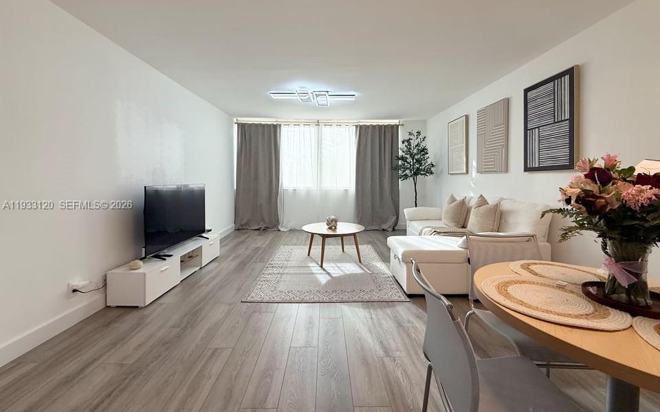 9125 Southwest 77th Avenue, Unit 307 Miami, FL 33156 - Photo 9 of 21 a living room with furniture and wooden floor