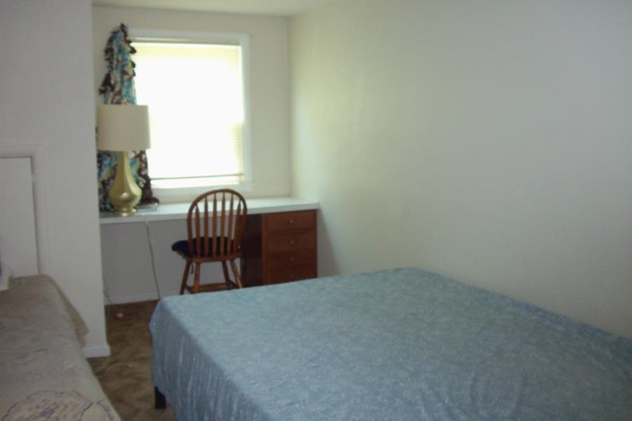 1210 South Prairie Avenue Freeport, IL 61032 - Photo 15 of 22 a bed sitting in a bedroom next to a window