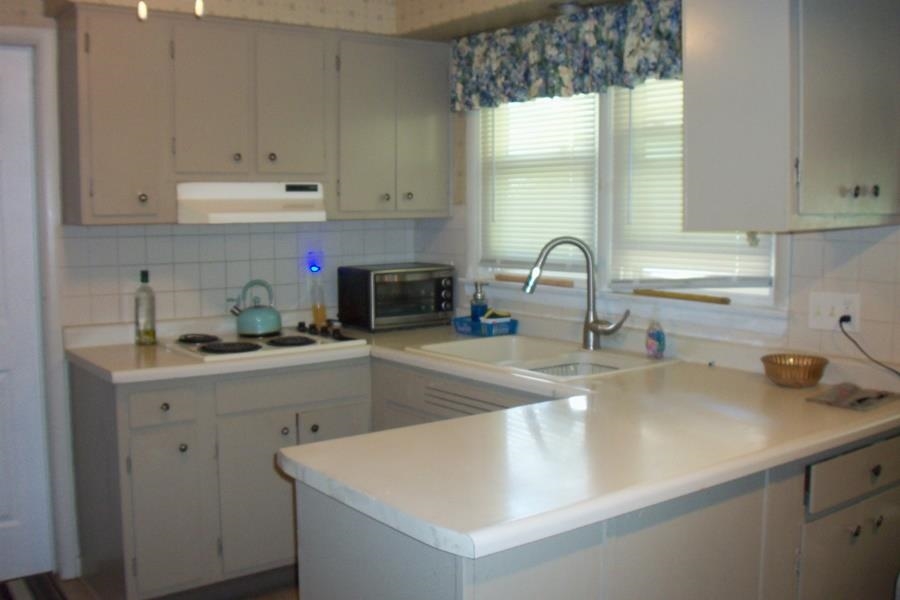 1210 South Prairie Avenue Freeport, IL 61032 - Photo 7 of 22 a kitchen with granite countertop a sink a stove and cabinets