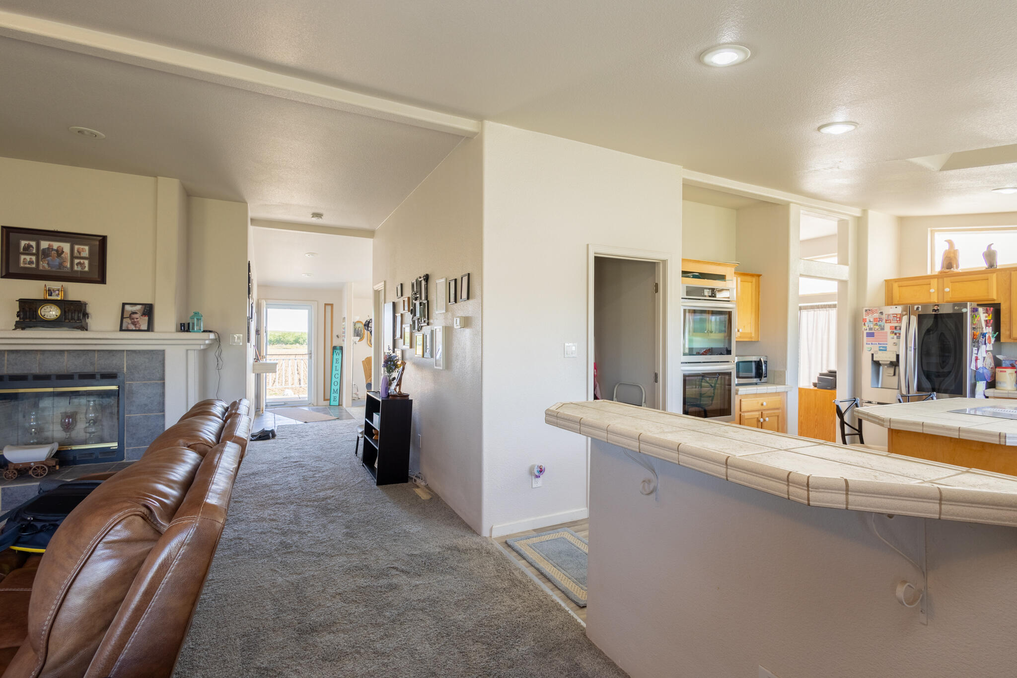 20735 Gyle Road Corning, CA 96021 - Photo 14 of 39 a large living room with stainless steel appliances furniture a fireplace and a large window