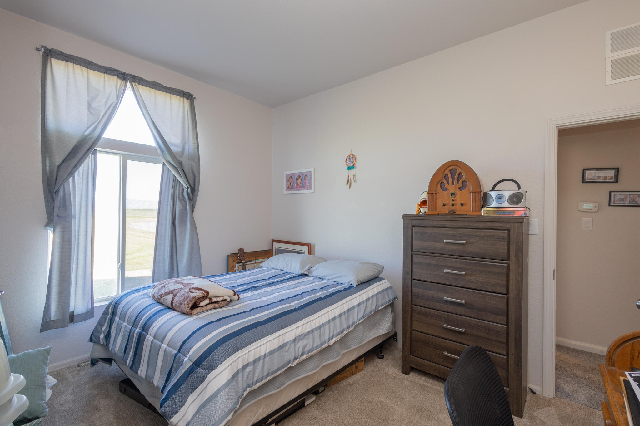 20735 Gyle Road Corning, CA 96021 - Photo 20 of 39 a bedroom with a bed and a dresser