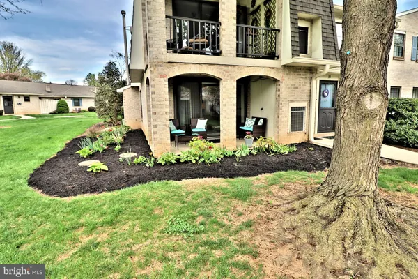 a front view of a house with yard and green space