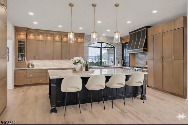 a large kitchen with a table and chairs