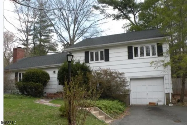 a house that has a tree in front of the house