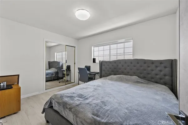 a bedroom with a bed and a couch