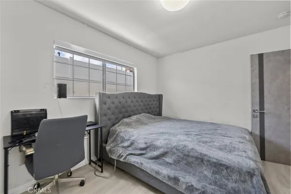 a bedroom with a bed and a desk