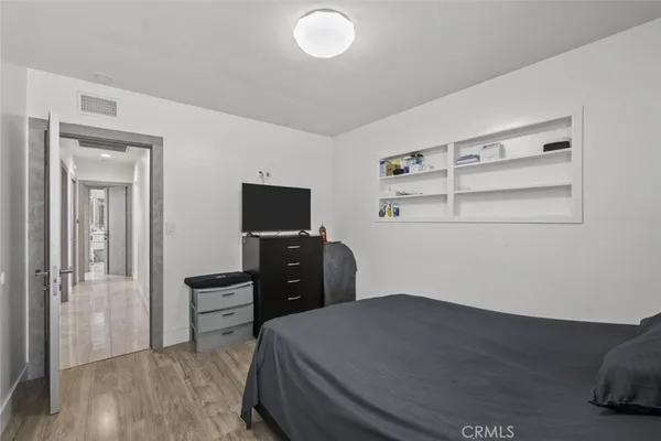 a bedroom with a bed and a tv