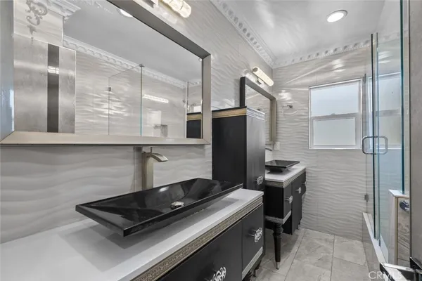 a room with chairs and stainless steel appliances