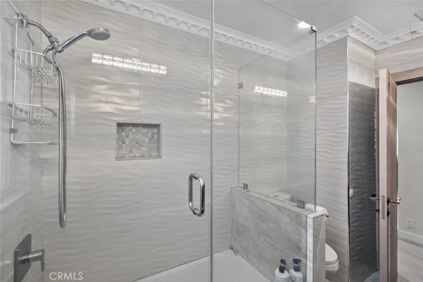 a bathroom with a shower and a sink