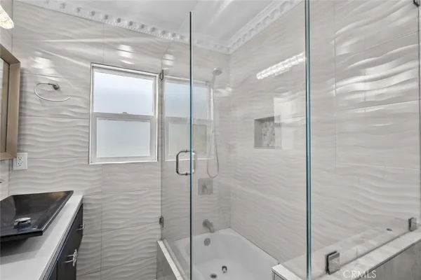 a bedroom with a bed and a view of kitchen