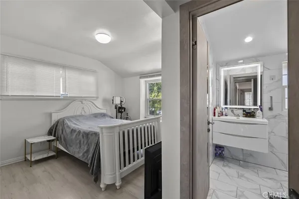 a bathroom with a sink mirror and a shower